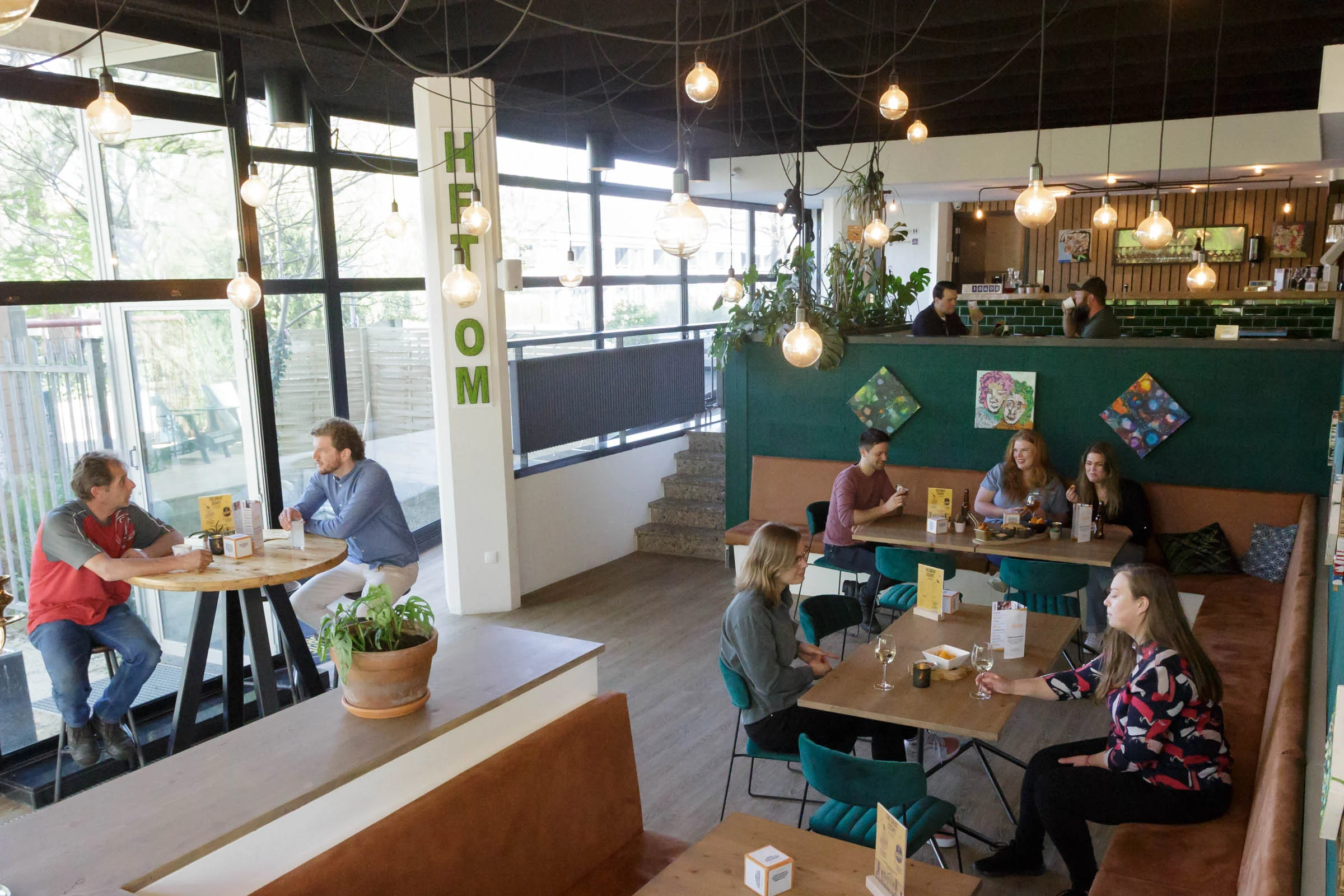 Cozy groups of people having drinks in the bright escape café.