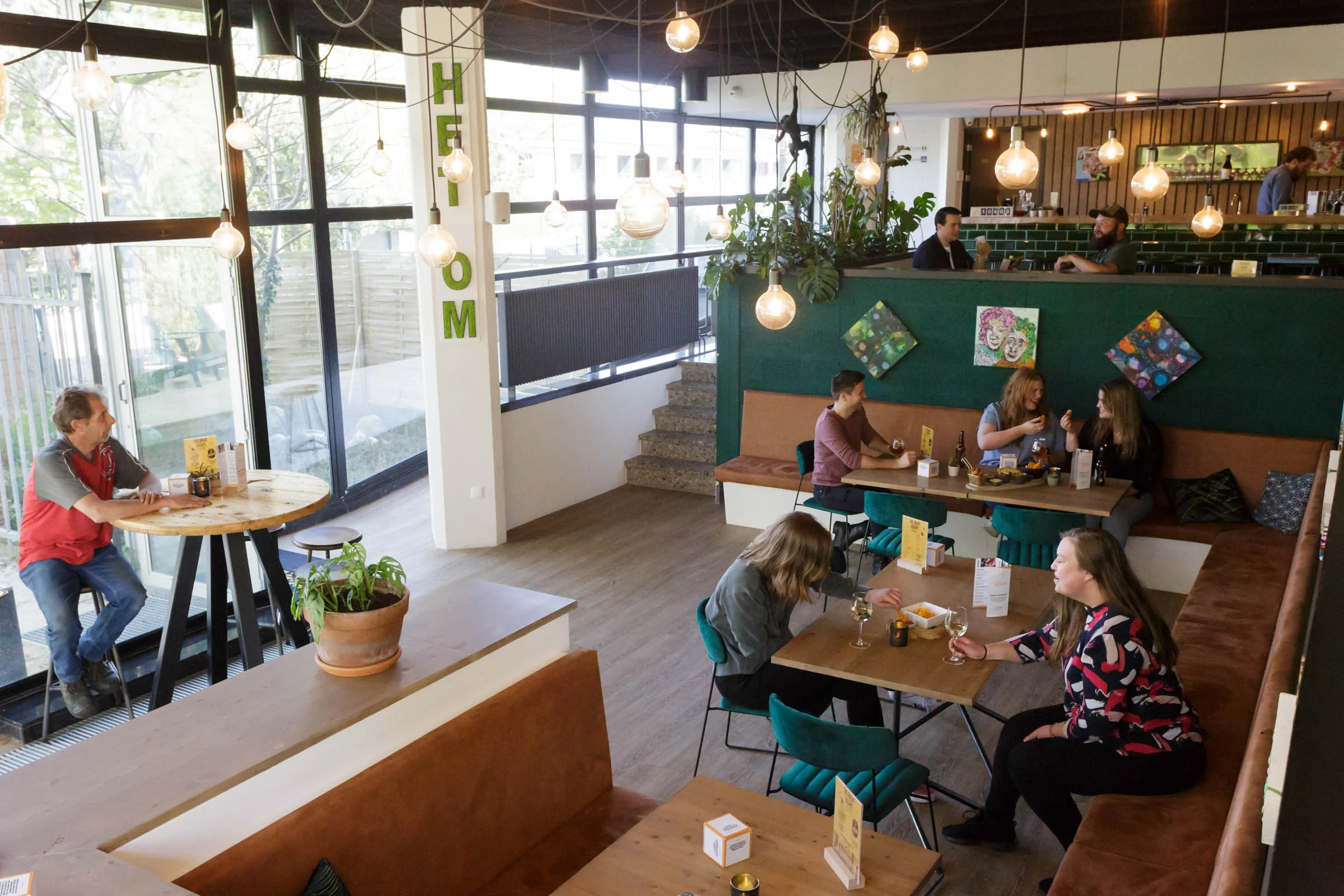 Cozy, modern escape café with a relaxed atmosphere and diverse visitors.
